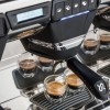 This image is a closeup front view of the Rancilio Classe 7 espresso machine brew groups, with traditional brew group and USB Volumetric Dosing Controls.